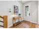 Inviting entryway featuring wood floors, stylish console table, and a front door with glass panels, offering natural light at 408 Old Town Village Rd, Waxhaw, NC 28173