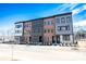 Row of new townhomes with varied architectural styles, landscaping, and a bright blue sky at 408 Old Town Village Rd, Waxhaw, NC 28173