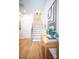 Bright foyer with wooden floors, a staircase, and a decorative table with lamp and plant at 408 Old Town Village Rd, Waxhaw, NC 28173
