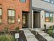 Charming townhome with a brick facade, concrete stairs, and a welcoming front entrance at 408 Old Town Village Rd, Waxhaw, NC 28173