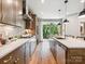 Modern kitchen with stainless steel appliances and a large island with barstool seating, perfect for dining and entertaining at 408 Old Town Village Rd, Waxhaw, NC 28173
