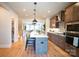 Modern kitchen featuring an island with seating, sleek appliances and a large pantry nearby at 408 Old Town Village Rd, Waxhaw, NC 28173