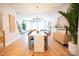 Open-concept living and dining area with hardwood floors and modern lighting at 408 Old Town Village Rd, Waxhaw, NC 28173