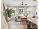 Bright living room with large windows, modern decor, and hardwood floors at 408 Old Town Village Rd, Waxhaw, NC 28173