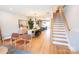 Open floor plan with a modern kitchen and dining area with staircase at 408 Old Town Village Rd, Waxhaw, NC 28173
