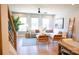 Bright living room featuring a white sectional sofa, large windows, and stylish decor at 408 Old Town Village Rd, Waxhaw, NC 28173