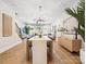 Spacious living and dining area with hardwood floors, modern decor, and plenty of natural light, ideal for entertaining guests at 408 Old Town Village Rd, Waxhaw, NC 28173