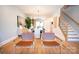 Open floor plan with dining area, chairs, and staircase with modern accents at 408 Old Town Village Rd, Waxhaw, NC 28173