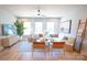Cozy living room featuring a white sectional sofa, large windows, and stylish decor at 408 Old Town Village Rd, Waxhaw, NC 28173