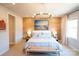 Bright main bedroom features a wood accent wall, stylish chandelier, and coastal artwork at 408 Old Town Village Rd, Waxhaw, NC 28173
