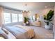 Serene main bedroom featuring a plush bed, decorative lighting, and ample natural light at 408 Old Town Village Rd, Waxhaw, NC 28173