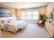 Serene main bedroom featuring a plush bed, decorative lighting, and ample natural light at 408 Old Town Village Rd, Waxhaw, NC 28173