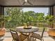 Outdoor patio features a round table with four chairs, greenery, and natural views at 408 Old Town Village Rd, Waxhaw, NC 28173