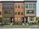 Exterior view of new construction townhomes with brick and siding, professional landscaping at 408 Old Town Village Rd, Waxhaw, NC 28173