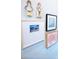 Gallery wall featuring assorted framed art pieces on a light blue painted wall at 408 Old Town Village Rd, Waxhaw, NC 28173