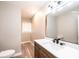 Modern bathroom featuring wood cabinets, a quartz countertop, and a stylish mirror at 4221 E Maiden Rd, Maiden, NC 28650