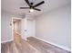 Bright bedroom features hardwood floors, a modern ceiling fan, and a closet with open doors at 4221 E Maiden Rd, Maiden, NC 28650