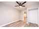 Bright bedroom features hardwood floors, a modern ceiling fan, and an open door to another room at 4221 E Maiden Rd, Maiden, NC 28650