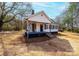 Inviting exterior view showcasing the front porch, well-maintained siding, and mature trees surrounding the property at 4221 E Maiden Rd, Maiden, NC 28650