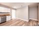 Modern kitchen dining area with hardwood floors, white cabinets, and stainless steel appliances at 4221 E Maiden Rd, Maiden, NC 28650