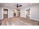 Open-concept living room with wood flooring and multiple doorways, neutral paint at 4221 E Maiden Rd, Maiden, NC 28650