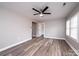Bright living room with new flooring, ceiling fan, and neutral paint, offering a comfortable and modern living space at 4221 E Maiden Rd, Maiden, NC 28650