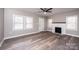 Bright living room with new flooring, a fireplace, and lots of natural light, offering a comfortable living space at 4221 E Maiden Rd, Maiden, NC 28650