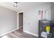 Bright utility room with durable flooring and updated water heater for efficient home maintenance at 4221 E Maiden Rd, Maiden, NC 28650