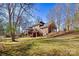 Back exterior view of brick home with wooden deck, stairs to backyard and garage at 4340 Rodeway Ne Ct, Hickory, NC 28601