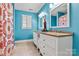 Vibrant bathroom with double vanity, granite countertop, decorative statue, and a shower with a patterned curtain at 4340 Rodeway Ne Ct, Hickory, NC 28601