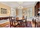 Dining room featuring hardwood floors, a large dining table, and plantation shutters for ample natural light at 4340 Rodeway Ne Ct, Hickory, NC 28601
