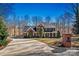 Inviting brick home with lush landscaping and a long driveway, framed by mature trees at 4340 Rodeway Ne Ct, Hickory, NC 28601