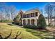 Charming two-story brick home with a columned front porch and manicured landscaping at 4340 Rodeway Ne Ct, Hickory, NC 28601
