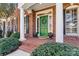 Charming front porch with brick steps, pillars, a green door with wreath, and manicured bushes at 4340 Rodeway Ne Ct, Hickory, NC 28601