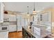 Bright kitchen featuring white cabinets, stainless appliances, and a kitchen island at 4340 Rodeway Ne Ct, Hickory, NC 28601