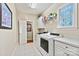 Functional laundry room equipped with modern washer and dryer units, cabinetry, and ample counter space at 4340 Rodeway Ne Ct, Hickory, NC 28601