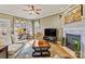 Cozy living room with a fireplace, a ceiling fan, and many windows at 4340 Rodeway Ne Ct, Hickory, NC 28601