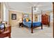 The main bedroom has a four-poster bed and windows with plantation shutters at 4340 Rodeway Ne Ct, Hickory, NC 28601