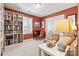 Inviting home office with a built-in bookshelf, classic desk, and a comfortable striped seating area at 4340 Rodeway Ne Ct, Hickory, NC 28601
