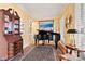 Elegant piano room featuring a grand piano, wooden desk, and large windows with natural light at 4340 Rodeway Ne Ct, Hickory, NC 28601