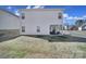 View of the house from the backyard, showing the outdoor seating area and well-maintained lawn at 4631 Christina Ct, Gastonia, NC 28056