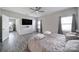 Spacious bedroom with wood-look flooring, modern ceiling fan, and natural light at 4631 Christina Ct, Gastonia, NC 28056