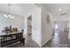 Hallway shot of open-concept dining area features modern lighting, wood flooring, and seamless flow to kitchen and living areas at 4631 Christina Ct, Gastonia, NC 28056