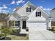 Charming two-story home featuring a two-car garage, stone accents, and a well-maintained lawn, ideal for suburban living at 4631 Christina Ct, Gastonia, NC 28056