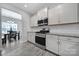 Modern kitchen with white cabinetry, granite countertops, stainless steel appliances, and tile backsplash with wood flooring at 4631 Christina Ct, Gastonia, NC 28056