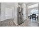 Features stainless steel refrigerator, gray flooring, and access to the dining area in this spacious kitchen at 4631 Christina Ct, Gastonia, NC 28056