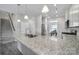 Modern kitchen with granite island, stainless steel appliances, and ample storage, connecting seamlessly to the dining area at 4631 Christina Ct, Gastonia, NC 28056
