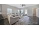 Bright living room with a large sectional sofa, wood-look floors, and a door leading to the outdoor space at 4631 Christina Ct, Gastonia, NC 28056
