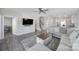 Open-concept living room with a ceiling fan, wood-look floors, and a staircase leading to the upper level at 4631 Christina Ct, Gastonia, NC 28056