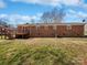 Backyard showcasing a wooden deck and a spacious grassy area, ideal for outdoor activities at 5012 Maplecrest Dr, Gastonia, NC 28056